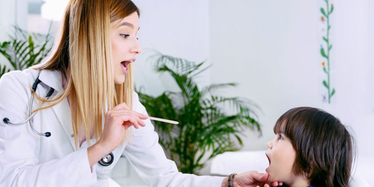 pediatrician-examining-little-boy-s-throat-2021-08-26-16-53-45-utc-min.jpg